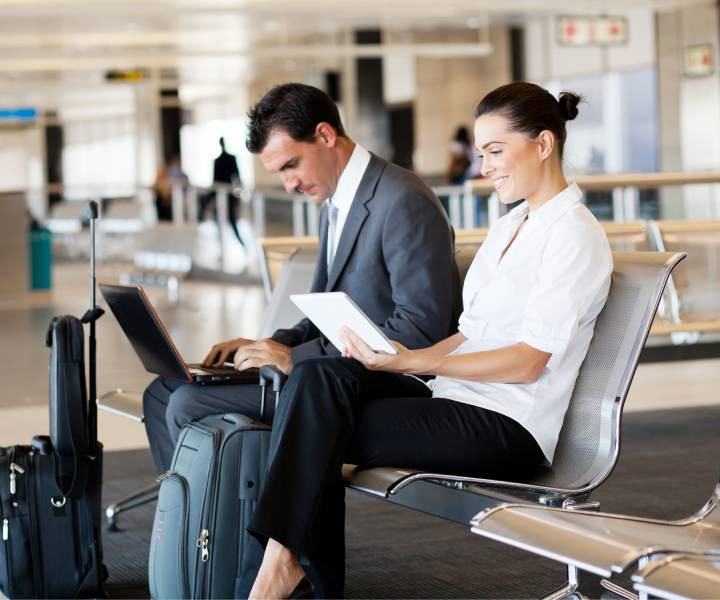 Business travelers waiting for their flight at airport