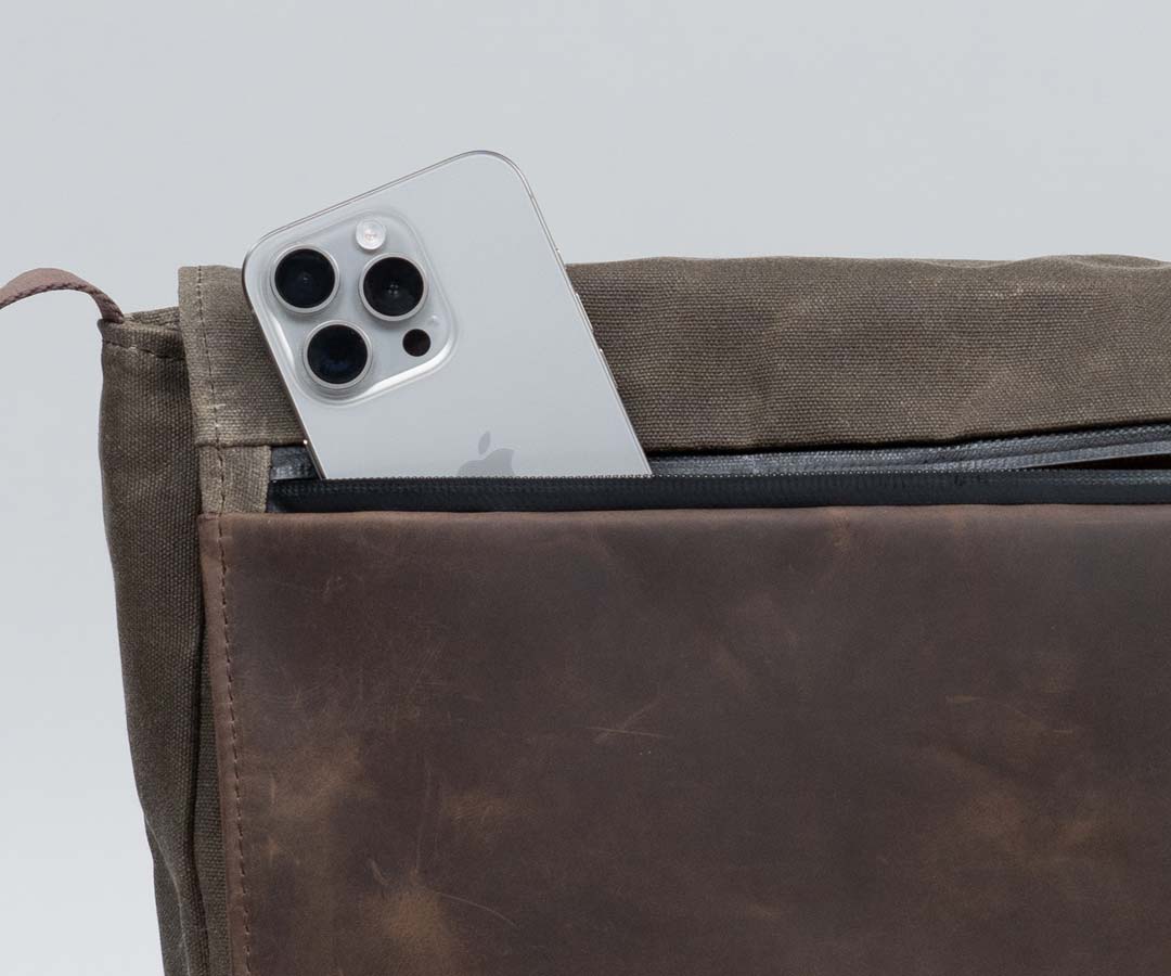 Full-grain leather flap with water-resistant zipper