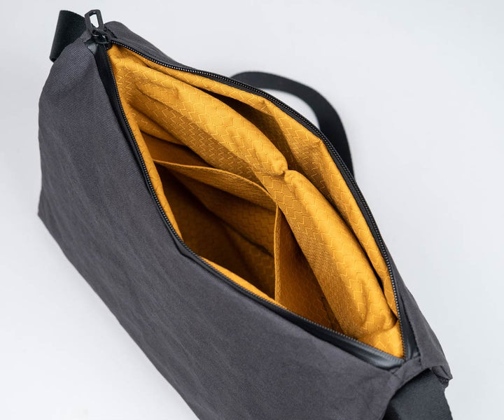 Eye-popping gold nylon lines the interior and flap pockets