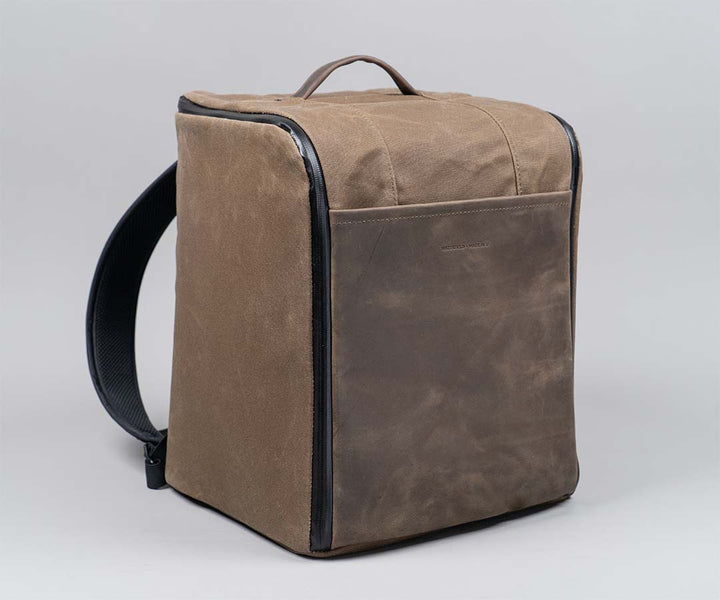 In waxed canvas wtih full-grain leather panel and water-resistant zipper