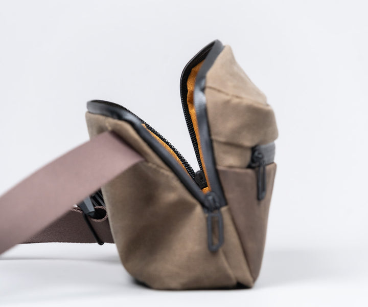 Diagonal zipper design for greater access to main compartment