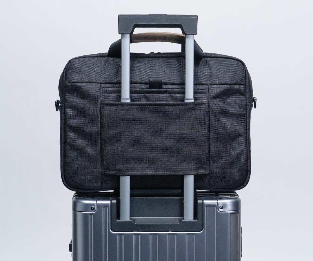 Rear slot slips onto luggage handles