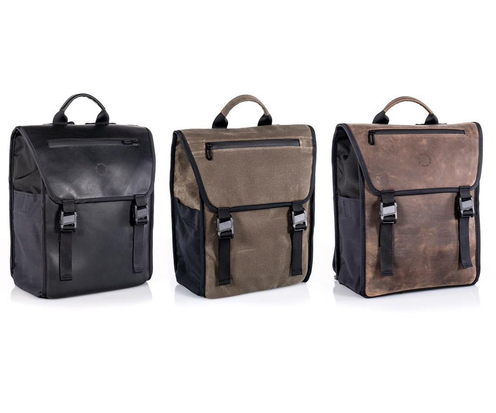  In black ballistic nylon + full-grain  leather,  all-waxed canvas