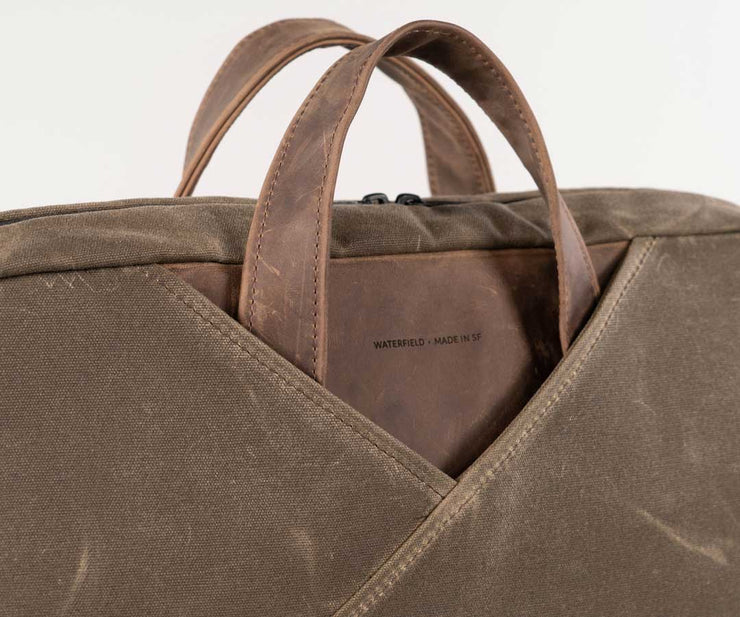 The front panel highlights the single, asymmetric fold that inspired the brief's design 
