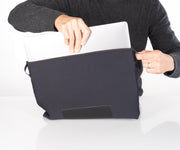 Use side tabs to help insert and remove laptop