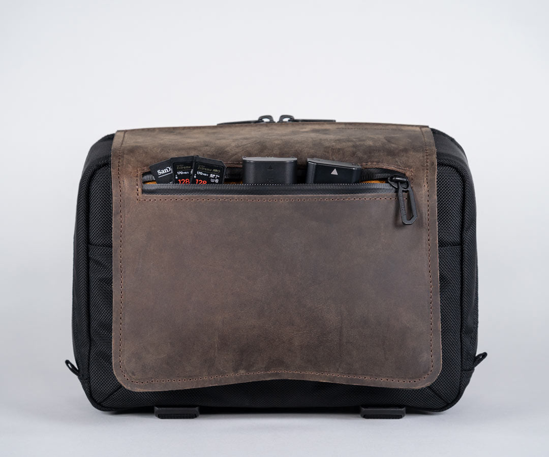 Full-grain leather flap stores frequently-accessed items